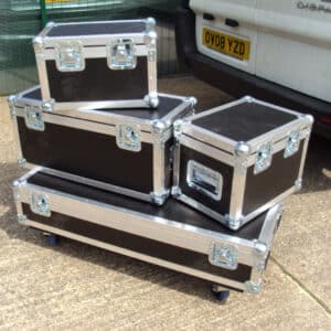 assorted sizes of custom flight cases shown stacked